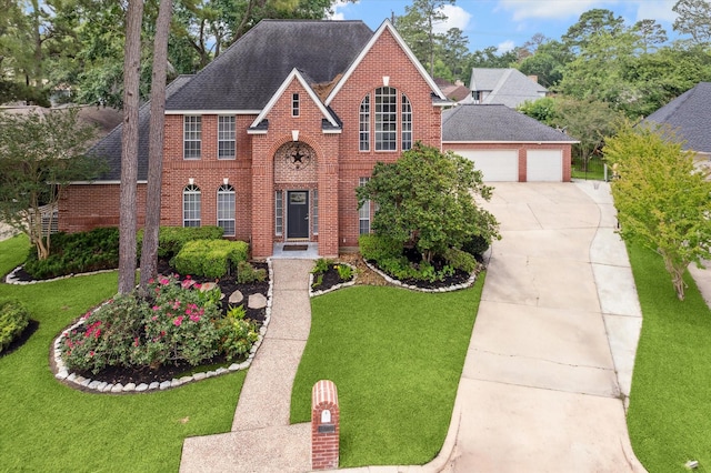 18715 Big Cypress Dr, Spring, TX 77388 - view of front facade featuring brick siding, roof with shingles, and a front yard