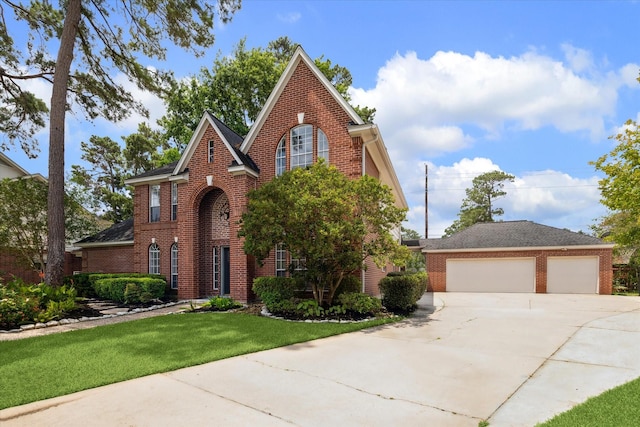 18715 Big Cypress Dr, Spring, TX 77388 - traditional-style home with brick siding, a front lawn, driveway, and a garage