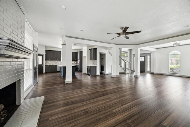 18715 Big Cypress Dr, Spring, TX 77388 - unfurnished living room with a fireplace, dark wood-style floors, ceiling fan, and stairway