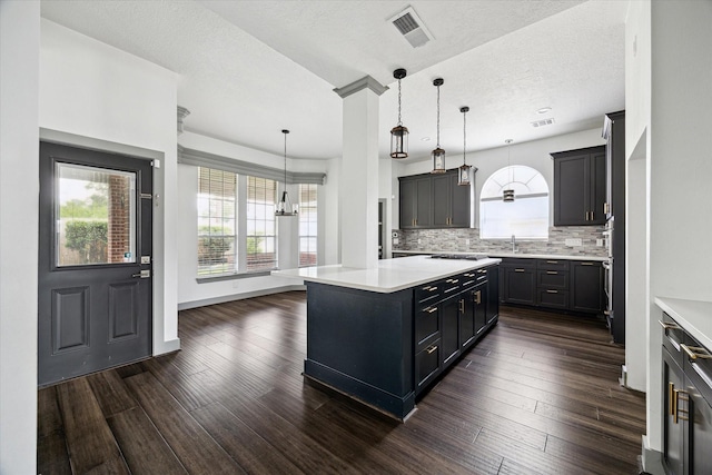 18715 Big Cypress Dr, Spring, TX 77388 - kitchen featuring a sink, light countertops, stovetop, dark wood-style floors, and a textured ceiling
