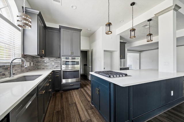 18715 Big Cypress Dr, Spring, TX 77388 - kitchen with stainless steel appliances, a sink, dark wood finished floors, decorative backsplash, and a textured ceiling