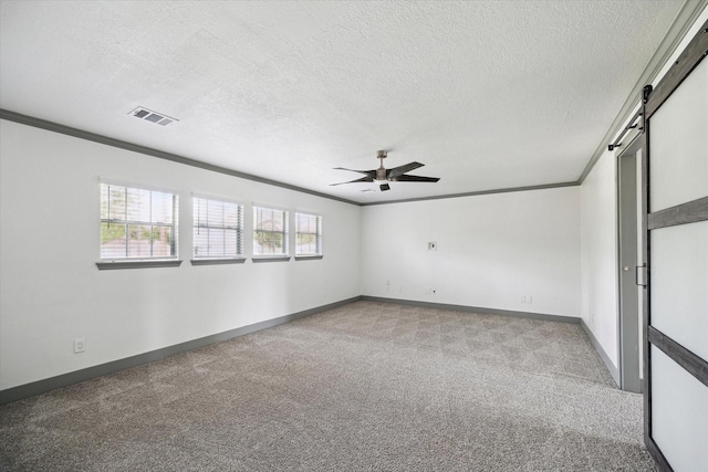 18715 Big Cypress Dr, Spring, TX 77388 - carpeted empty room featuring ornamental molding, a barn door, ceiling fan, a textured ceiling, and baseboards