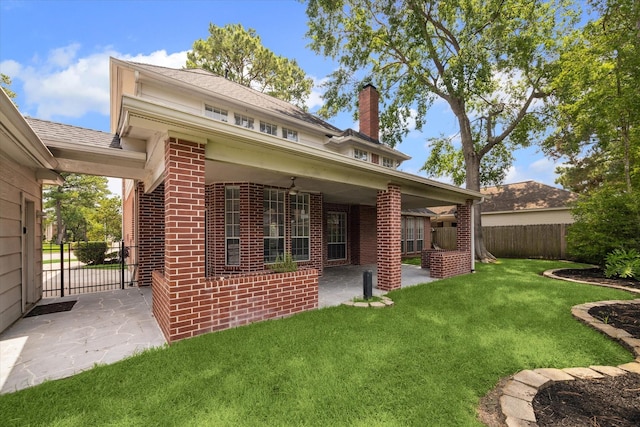18715 Big Cypress Dr, Spring, TX 77388 - rear view of property featuring brick siding, a chimney, and a patio