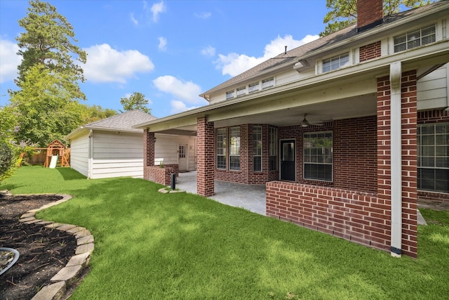 18715 Big Cypress Dr, Spring, TX 77388 - rear view of property with a playground, brick siding, a patio area, and a lawn