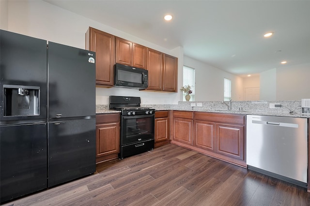 6718 Forbes Run Dr, Houston, TX 77075 - kitchen featuring black appliances, a sink, dark wood-style floors, light stone countertops, and recessed lighting