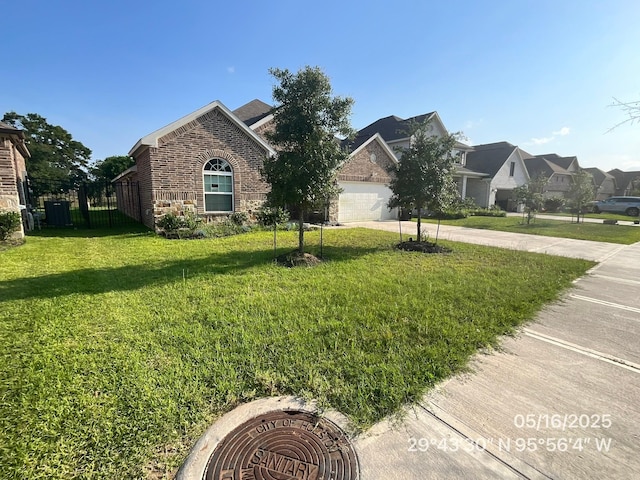 32743 Turning Springs Dr, Brookshire, TX 77423 - view of front of house with brick siding, a front lawn, concrete driveway, an attached garage, and a residential view