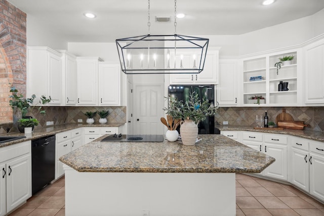 35 Dewdrift Pl, The Woodlands, TX 77382 - kitchen with black appliances, open shelves, a kitchen island, white cabinetry, and decorative backsplash