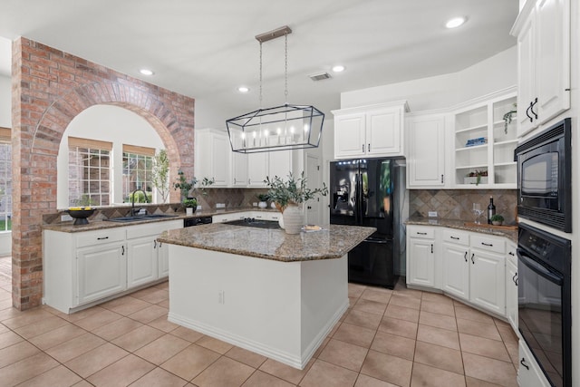 35 Dewdrift Pl, The Woodlands, TX 77382 - kitchen with black appliances, a sink, open shelves, decorative backsplash, and light tile patterned floors