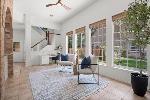 35 Dewdrift Pl, The Woodlands, TX 77382 - living area with light tile patterned floors, a ceiling fan, plenty of natural light, stairs, and a high ceiling