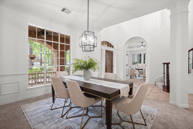 35 Dewdrift Pl, The Woodlands, TX 77382 - dining room featuring plenty of natural light, light colored carpet, a chandelier, baseboards, and ornamental molding
