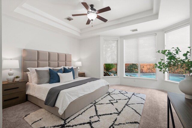 35 Dewdrift Pl, The Woodlands, TX 77382 - bedroom with a raised ceiling, carpet floors, ceiling fan, and baseboards