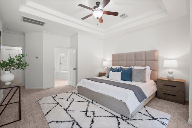 35 Dewdrift Pl, The Woodlands, TX 77382 - bedroom featuring a raised ceiling, light colored carpet, ensuite bath, baseboards, and crown molding