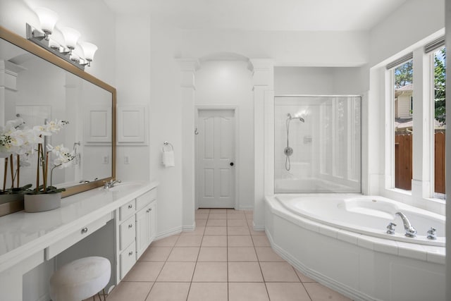 35 Dewdrift Pl, The Woodlands, TX 77382 - full bathroom with a garden tub, vanity, a stall shower, tile patterned flooring, and ornate columns