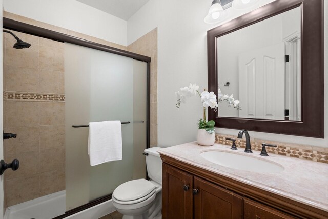 35 Dewdrift Pl, The Woodlands, TX 77382 - bathroom featuring vanity, a shower stall, and toilet