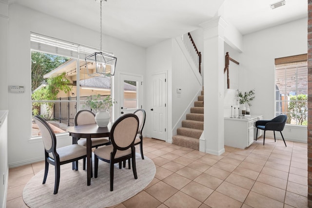 35 Dewdrift Pl, The Woodlands, TX 77382 - dining room with healthy amount of natural light, light tile patterned floors, and a chandelier