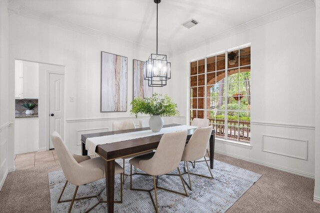 35 Dewdrift Pl, The Woodlands, TX 77382 - dining room with light carpet, crown molding, and a chandelier