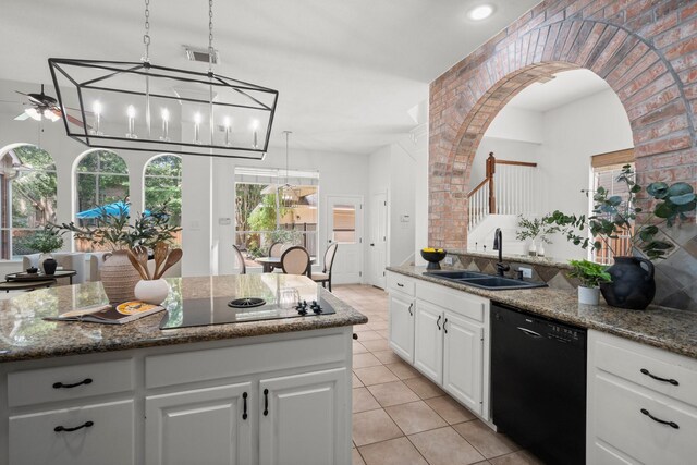 35 Dewdrift Pl, The Woodlands, TX 77382 - kitchen featuring black appliances, a sink, light tile patterned flooring, white cabinetry, and dark stone counters