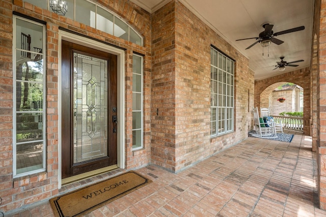 35 Dewdrift Pl, The Woodlands, TX 77382 - doorway to property featuring a porch, ceiling fan, and brick siding