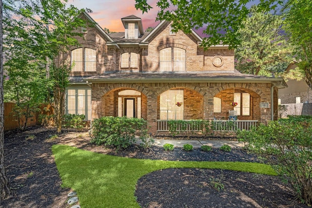 35 Dewdrift Pl, The Woodlands, TX 77382 - view of front facade featuring a porch and brick siding
