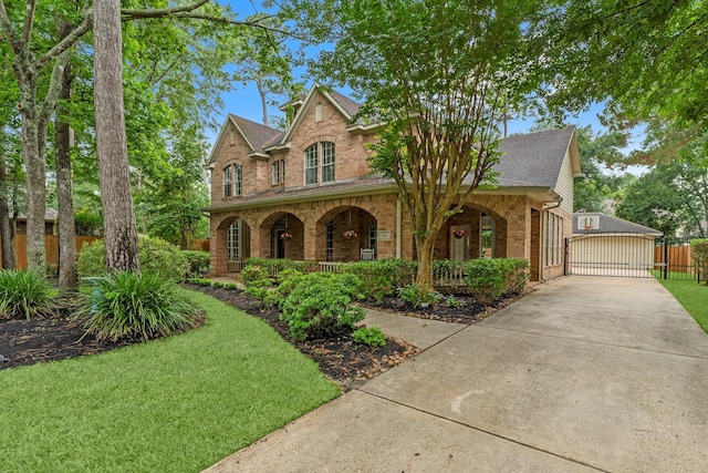 35 Dewdrift Pl, The Woodlands, TX 77382 - traditional-style home featuring brick siding, covered porch, roof with shingles, a garage, and a gate