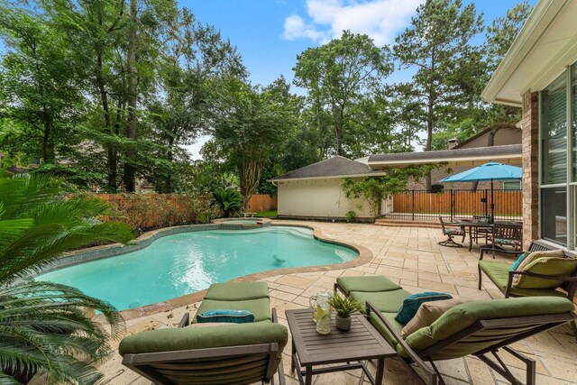 35 Dewdrift Pl, The Woodlands, TX 77382 - view of pool featuring a patio area, a fenced backyard, and a pool with connected hot tub