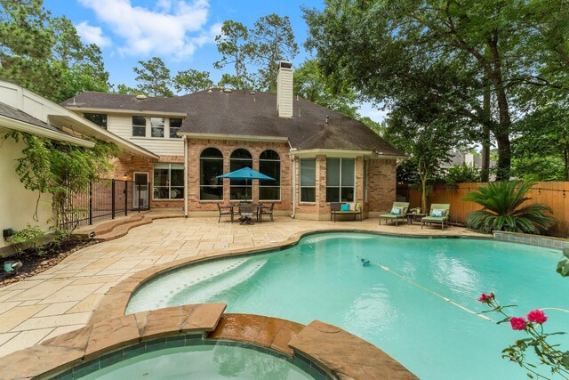 35 Dewdrift Pl, The Woodlands, TX 77382 - view of pool with a patio, a fenced backyard, and a pool with connected hot tub