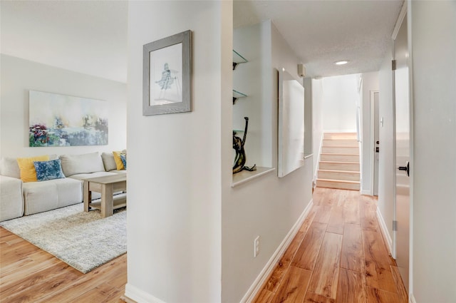2014 Augusta Dr, Houston, TX 77057 - hall featuring light wood finished floors, stairway, and baseboards
