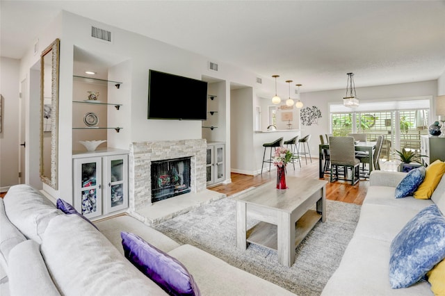 2014 Augusta Dr, Houston, TX 77057 - living room featuring wood finished floors, a fireplace, and baseboards