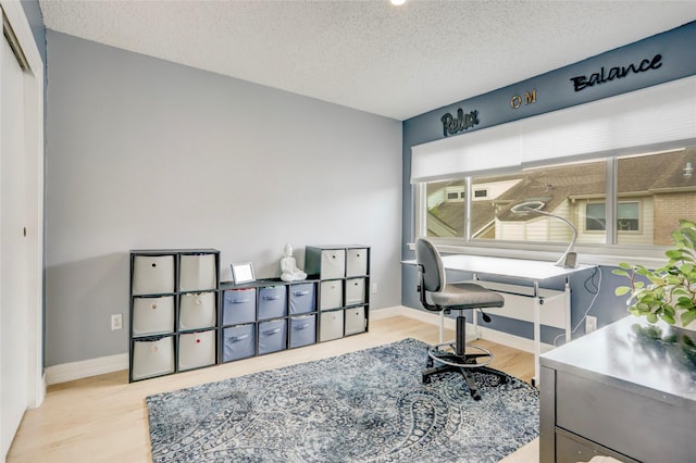 2014 Augusta Dr, Houston, TX 77057 - home office featuring wood finished floors, a textured ceiling, and baseboards