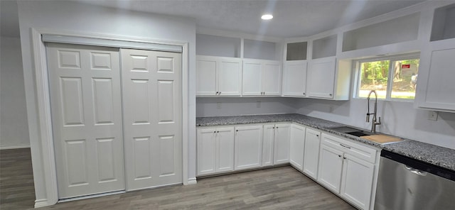 110 Hidden Cir, Coldspring, TX 77331 - kitchen with stainless steel dishwasher, a sink, white cabinets, light wood-style floors, and recessed lighting