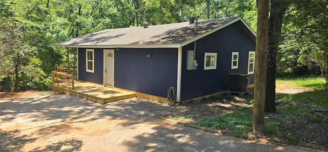 110 Hidden Cir, Coldspring, TX 77331 - view of front of house featuring central air condition unit, a wooden deck, and roof with shingles