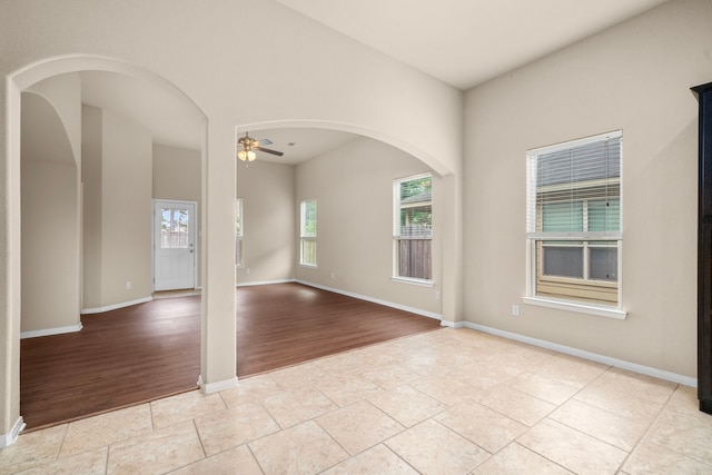 25426 Saddlebrook Champion Way, Tomball, TX 77375 - spare room with a ceiling fan, baseboards, and light wood finished floors
