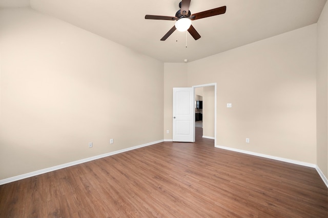 25426 Saddlebrook Champion Way, Tomball, TX 77375 - empty room featuring wood finished floors, baseboards, a ceiling fan, and vaulted ceiling
