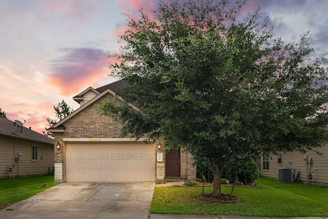 25426 Saddlebrook Champion Way, Tomball, TX 77375 - view of front of house with brick siding, central AC, driveway, a garage, and a yard