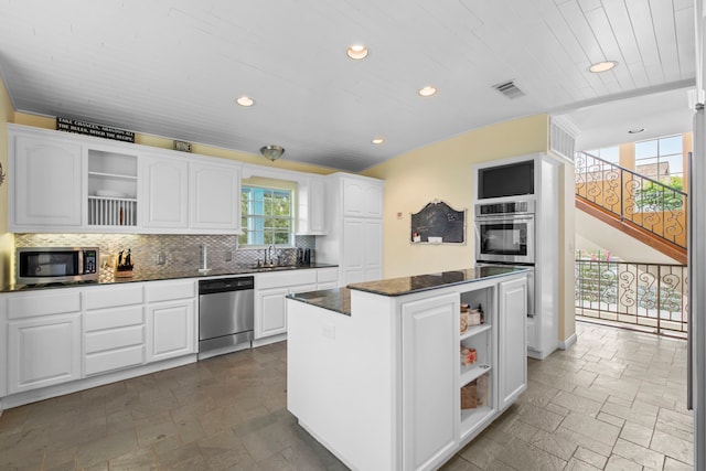 718 Pine Rd, Clear Lake Shores, TX 77565 - kitchen featuring appliances with stainless steel finishes, open shelves, recessed lighting, a kitchen island, and a sink