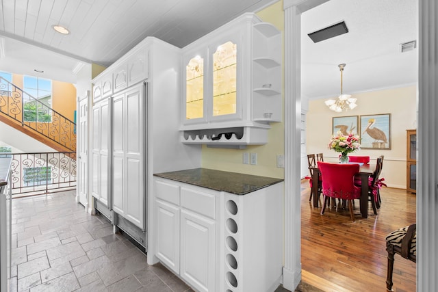 718 Pine Rd, Clear Lake Shores, TX 77565 - kitchen with dark countertops, ornamental molding, a chandelier, white cabinets, and recessed lighting