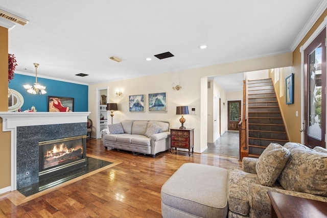 718 Pine Rd, Clear Lake Shores, TX 77565 - living area with wood-type flooring, stairs, a fireplace, crown molding, and recessed lighting