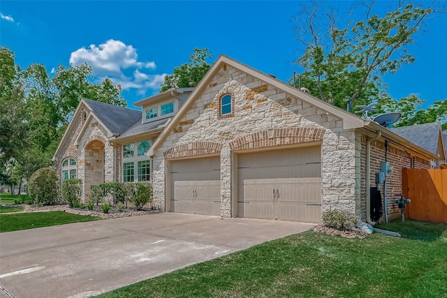 5918 Emmit Creek Ln, Sugar Land, TX 77479 - view of front of property featuring stone siding, driveway, a garage, a front yard, and roof with shingles