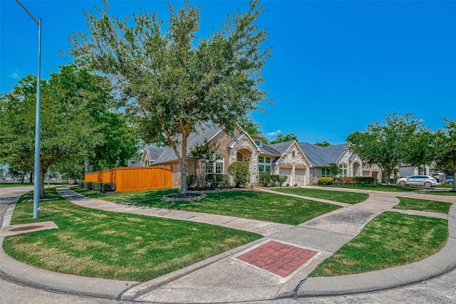 5918 Emmit Creek Ln, Sugar Land, TX 77479 - view of front of property with stone siding, a garage, driveway, and brick siding