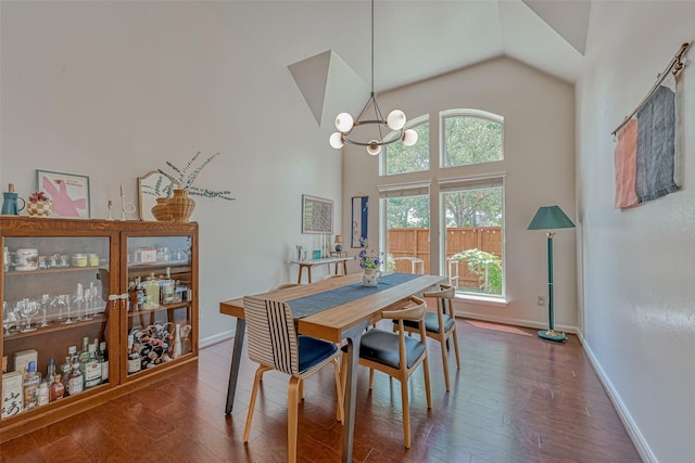 5918 Emmit Creek Ln, Sugar Land, TX 77479 - dining room with wood finished floors, baseboards, a chandelier, and high vaulted ceiling