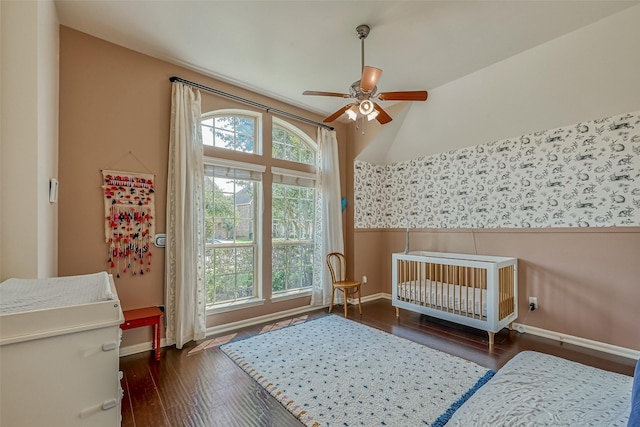 5918 Emmit Creek Ln, Sugar Land, TX 77479 - bedroom with baseboards, wood-type flooring, a crib, lofted ceiling, and a ceiling fan