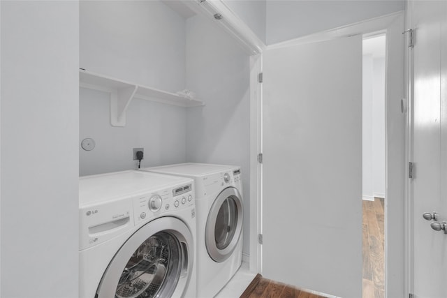 2719 Clay St, Houston, TX 77003 - laundry room with wood finished floors and washing machine and clothes dryer