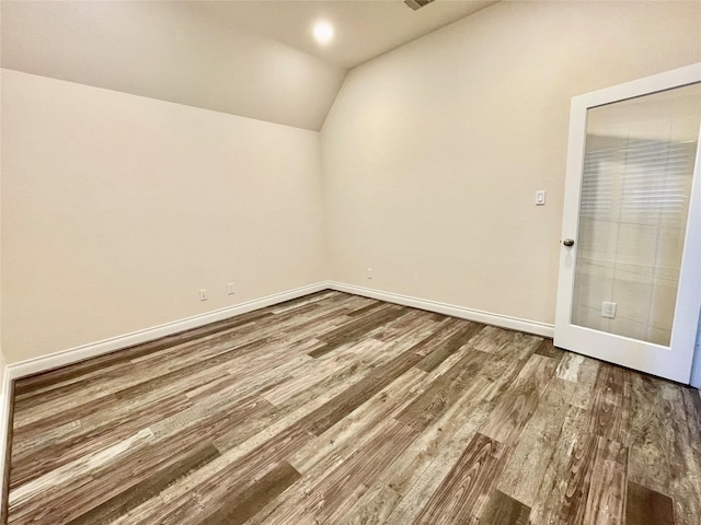 2023 Deer Vly, Missouri City, TX 77459 - spare room featuring lofted ceiling, wood finished floors, and baseboards