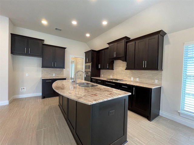 2023 Deer Vly, Missouri City, TX 77459 - kitchen with a sink, stainless steel appliances, baseboards, an island with sink, and tasteful backsplash