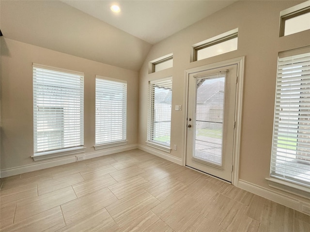 2023 Deer Vly, Missouri City, TX 77459 - doorway featuring lofted ceiling, baseboards, and wood finish floors