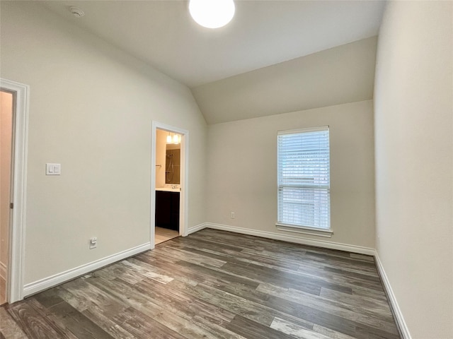 2023 Deer Vly, Missouri City, TX 77459 - unfurnished bedroom featuring lofted ceiling, wood finished floors, baseboards, and ensuite bathroom