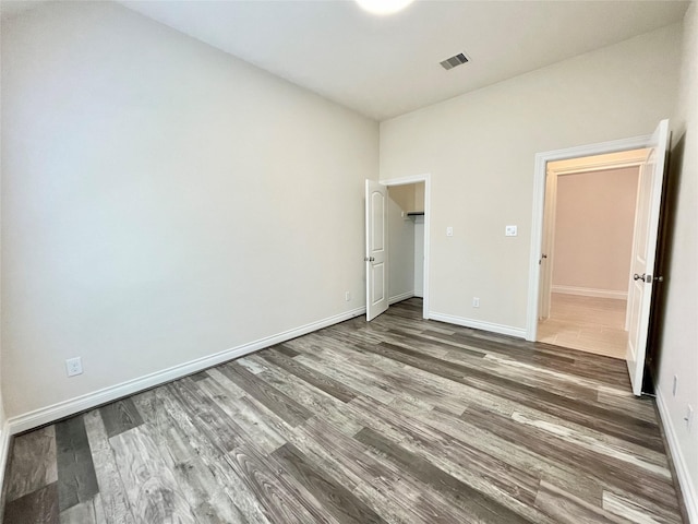 2023 Deer Vly, Missouri City, TX 77459 - unfurnished bedroom featuring wood finished floors and baseboards