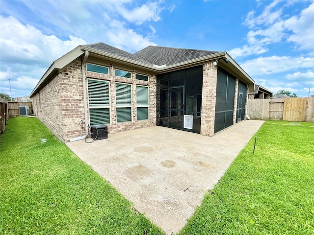 2023 Deer Vly, Missouri City, TX 77459 - back of property with a sunroom, brick siding, roof with shingles, and a patio area