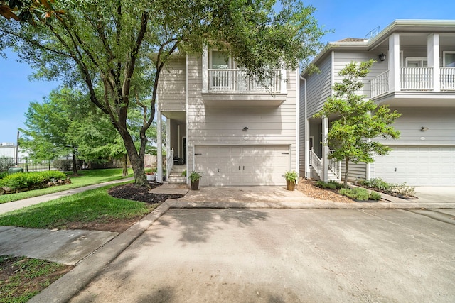 3303 New Garden View Ln, Houston, TX 77018 - view of front of house with a balcony, an attached garage, stairway, and driveway