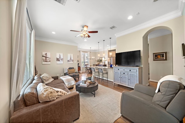 3303 New Garden View Ln, Houston, TX 77018 - living room featuring a ceiling fan, arched walkways, dark wood-style floors, ornamental molding, and recessed lighting